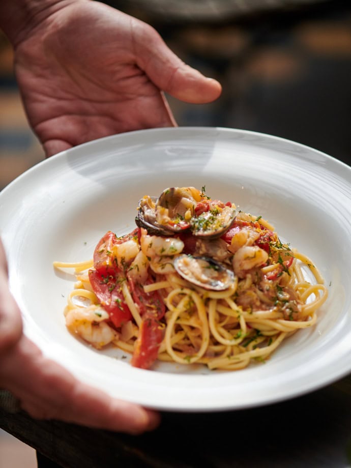 0019 - 2021 - Gees Restaurant & Bar - Oxford - High res - Food Hands Pasta Seafood - Web Feature